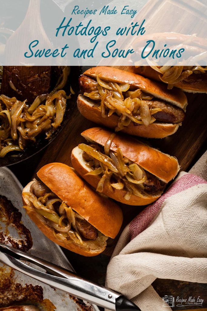 hot dogs with sweet and sour onions on a wooden board.