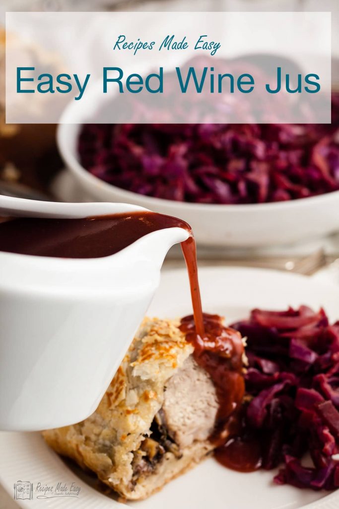 Pouring red wine jus onto a pork wellington.