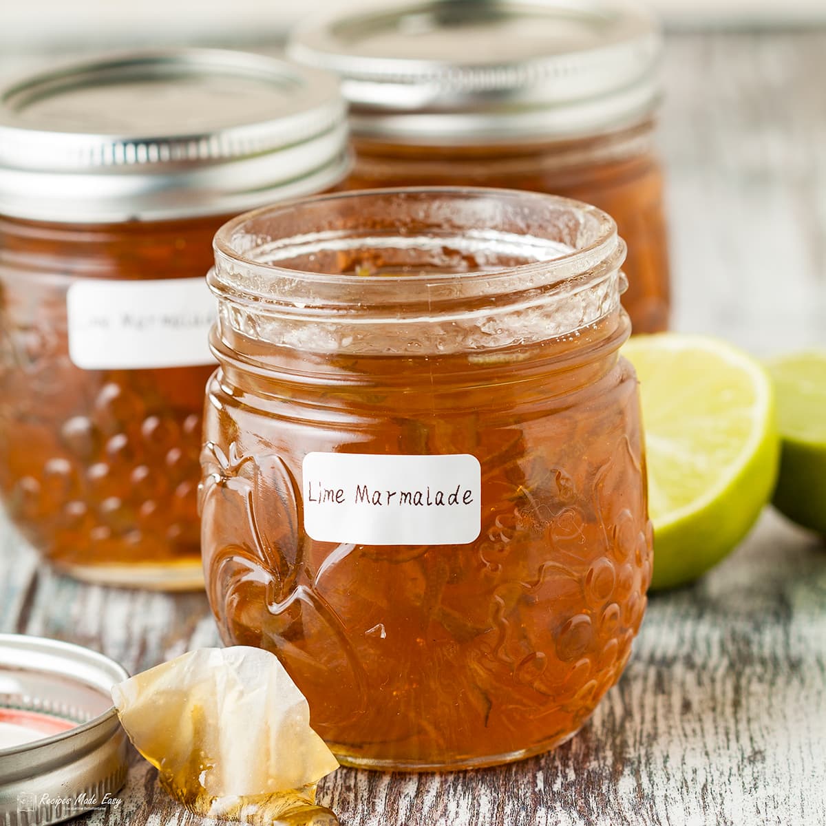 3 jars of lime marmalade front jar open.